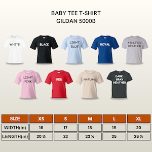 May include: A display of baby tee shirts in various colors, including white, black, light blue, royal blue, athletic heather, light pink, red, natural, and dark gray heather. The shirts are arranged above a size chart with measurements in inches.
