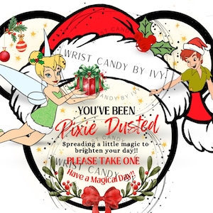 May include: A graphic design featuring Tinker Bell and Peter Pan in Santa hats, holding a gift. Text reads: WRIST CANDY BY IVY, YOU'VE BEEN Pixie Dusted, Spreading a little magic to brighten your day!! PLEASE TAKE ONE, Have a Magical Day!!