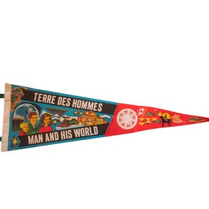 May include: A vintage pennant with a blue background and red trim. It features a colorful illustration of people and a globe, with the text "Terre des Hommes" and "Man and His World".