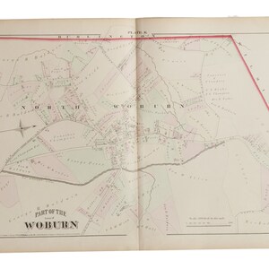 May include: A black and white map of Woburn, Massachusetts, showing the town's streets, roads, and property boundaries. The map is divided into two pages, with the town center on the left page and the surrounding area on the right page. The map is titled "Part of the Town of Woburn" and includes a scale bar and compass.