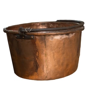 May include: A copper bucket with a dark metal handle and rim. The bucket has a hammered texture and a slightly oval shape. The handle is attached with black metal brackets. The bucket is isolated on a white background.