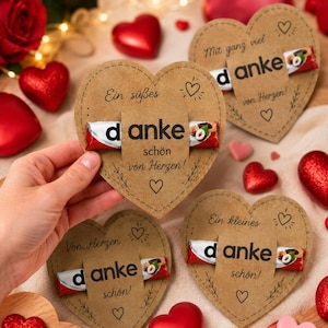 May include: Heart-shaped kraft paper cards featuring a chocolate bar held in the center. Each card displays the German text "danke sch&ouml;n von Herzen" or "Mit ganz viel danke von Herzen" with decorative line drawings of hearts and small floral sprigs.