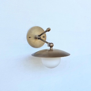 Flush-mount brass wall sconce—antique-style indoor lighting fixture