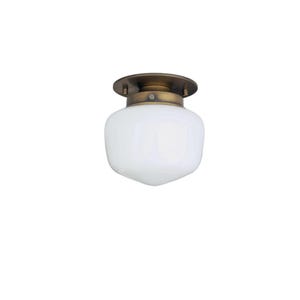 May include: A ceiling light fixture with a white, rounded glass shade and a brass-colored metal base. The fixture has a simple, classic design, suitable for various interior styles. The light is designed to be mounted flush against the ceiling.