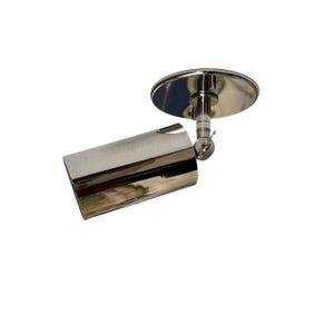 May include: A polished chrome spotlight fixture with a cylindrical body and a circular mounting plate. The light is adjustable with a ball joint and is designed for directional lighting.