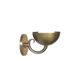 May include: A wall-mounted sconce with a brass finish. The sconce features a circular base, a curved arm, and a bowl-shaped shade. The shade holds a white light bulb. The design is simple and elegant, suitable for various interior styles.