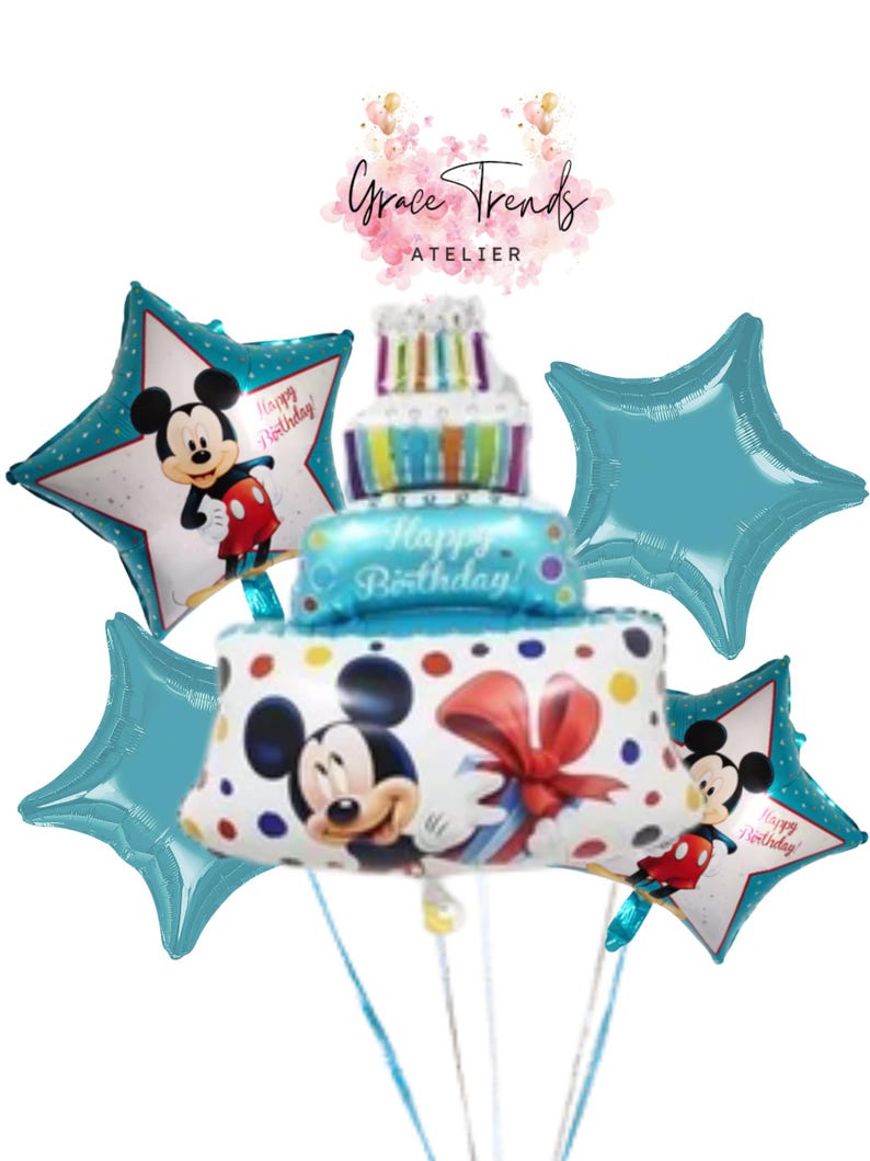 May include: A collection of blue and white Mickey Mouse-themed balloons. The centerpiece is a cake-shaped balloon with the words "Happy Birthday!" and a large Mickey Mouse balloon. Star-shaped balloons and the text "Grace Trends Atelier" are also visible.
