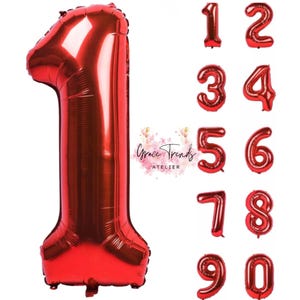 May include: A selection of red foil number balloons, including a large number one. Smaller balloons display the numbers 1 to 0. The shiny balloons are suitable for birthday parties or anniversaries. The image includes the text "Grace Trends Atelier".