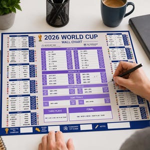 May include: A white A3 size 2026 World Cup wall chart with blue and purple accents. The chart features group stage tables, a knockout bracket, and sections for match scores, tournament top scorer, and notes, printed on a rectangular paper sheet.