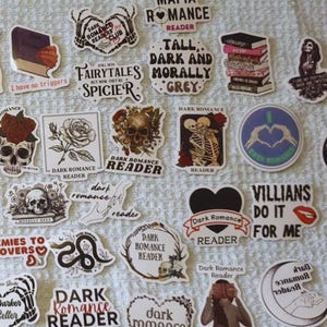 May include: A selection of stickers with a dark romantic theme. Designs include skulls, roses, skeletons, and phrases such as "Dark Romance Reader," "Villains Do It For Me," and "Mafia Romance Reader." The stickers are in various shapes and sizes.