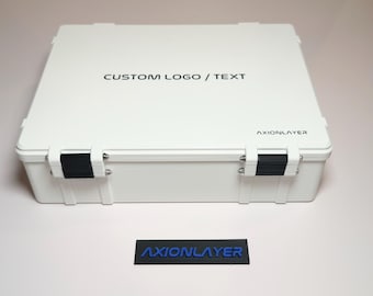 May include: A white rectangular case with black latches and silver hardware. The text "CUSTOM LOGO / TEXT" is printed on the lid in black. The text "AXIONLAYER" is printed on the case and on a separate black rectangle in blue.