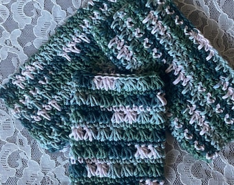 May include: A set of handmade crochet items in shades of green, blue, and pink. The set includes two rectangular washcloths and a square coaster. The items are made with a textured stitch, and the colors are blended throughout.