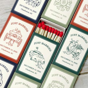 May include: A collection of rectangular matchboxes featuring various wedding-themed line art illustrations, including cars, carriages, and scooters. Each box is printed with the text JUST MARRIED, DECEMBER 14, 2026, and Charleston, SC, in different colors.