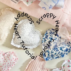 May include: A collection of handmade heart-shaped fabric ornaments in various patterns and colors. The hearts feature floral, striped, and patterned designs, with some trimmed with lace. The text "Scrappy Heart Tutorial" is written in a circle around the hearts.