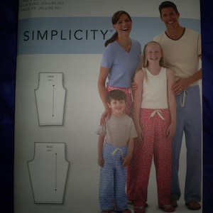 May include: A Simplicity pattern featuring a family wearing matching pajama pants. The pattern includes diagrams for child and adult sizes. The family is smiling and wearing pajamas in various colors and patterns.