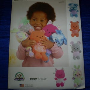 May include: A child holding several colorful stuffed animal toys. The toys include a bear, dog, and bunny. The image is a sewing pattern with the text "easy-to-sew".