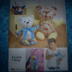 May include: A Learn to Sew pattern booklet featuring three teddy bear sewing projects. The bears are a white bear with a tie-dye pattern, a white bear with a blue bow and the text "Bubba Joel" on the chest, and a floral patterned bear.