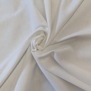 May include: White fabric with a smooth texture, folded and twisted into a spiral shape.