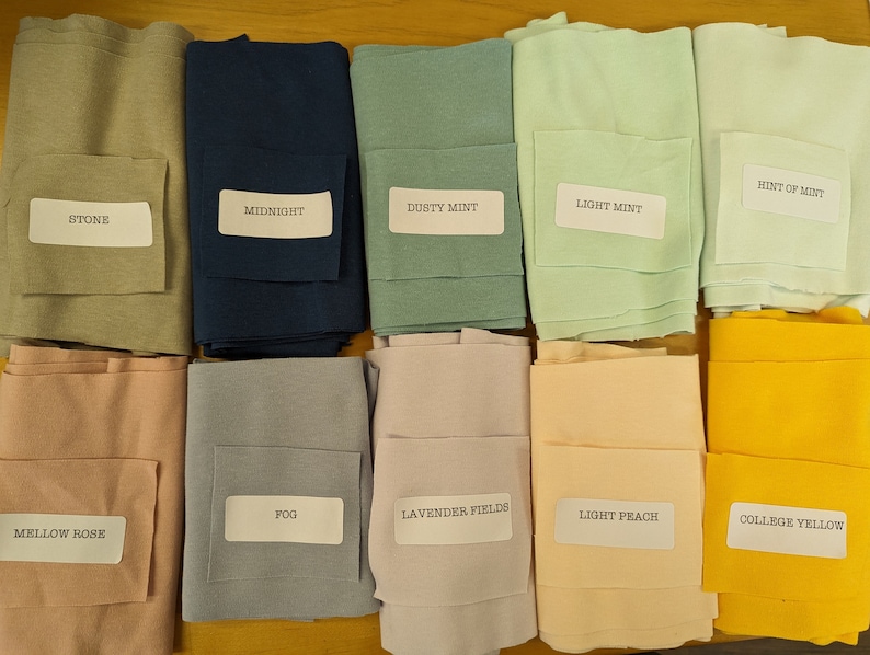 May include: Ten fabric swatches in various colors, including stone, midnight, dusty mint, light mint, hint of mint, mellow rose, fog, lavender fields, light peach, and college yellow.