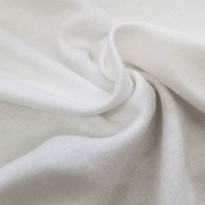 May include: White cotton fabric with a smooth texture and a slight sheen. The fabric is folded and draped, showing its soft and drapey nature.