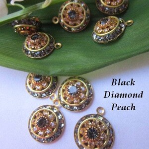 May include: Assortment of round, gold-toned metal charms with black and peach colored rhinestones. The charms have a flower-like design with a central black rhinestone surrounded by smaller peach rhinestones.
