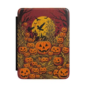 Op de afbeelding: Een rechthoekige e-readerhoes met een levendige Halloween-illustratie van talloze oranje pompoenen in een maïsveld. Een grote gele volle maan, zwarte kraaien en het silhouet van een huis zijn zichtbaar op de achtergrond.