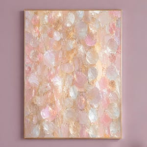 May include: A rectangular wall art piece featuring a dense, layered composition of iridescent, circular, and oval-shaped elements in shades of soft pink, peach, cream, and pale gold, all enclosed within a thin, metallic gold-colored frame.