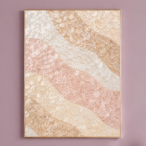 May include: A rectangular wall art piece featuring a textured surface composed of numerous small, overlapping circular elements in shades of cream, beige, and soft pink. The design consists of diagonal, wavy bands of color within a thin gold frame.