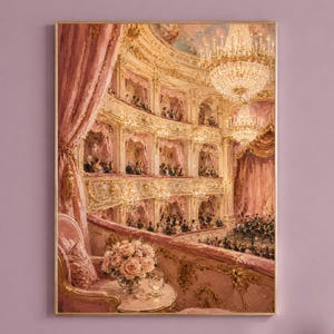 May include: A framed wall art print depicting an ornate opera house interior in shades of pink and gold. The scene features tiered balconies with audience members, large crystal chandeliers, heavy pink curtains, and a bouquet of flowers.