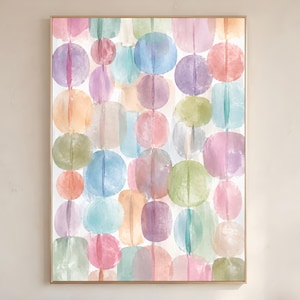 May include: A framed wall art print featuring a vertical pattern of watercolour circles and rounded shapes in pastel shades of pink, blue, purple, green, and orange. The artwork is composed of repeating translucent circular forms arranged in columns.