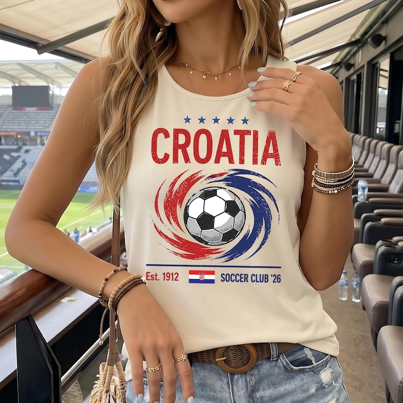 May include: A cream-colored sleeveless tank top featuring the word CROATIA in red, five blue stars, and a central graphic of a soccer ball surrounded by red and blue swirls. Below, the text reads Est. 1912, a small Croatian flag, and SOCCER CLUB '26.