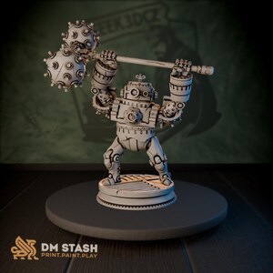 May include: A detailed, off-white robot figurine holding a barbell with two spiked balls. The robot has a circular base and is posed as if lifting the weight. The figurine is set on a dark gray platform.