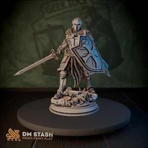 Puede incluir: Figura detallada de un caballero con armadura completa, sosteniendo una espada y un escudo. El caballero está sobre una base rocosa, con detalles intrincados en la armadura y las armas. El escudo presenta un diseño de cruz. La figura está pintada en tonos grises y blancos.