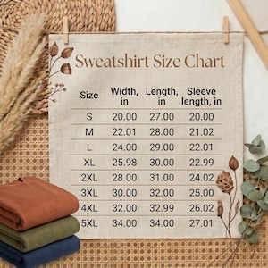 May include: Folded sweatshirts in rust, olive green, and navy blue are stacked below a pinned size chart. The chart details sizes S to 5XL, with measurements in inches for width, length, and sleeve length.