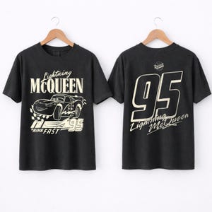 May include: Two black t-shirts with Lightning McQueen designs. The front of the shirt shows the character and text "Lightning McQueen", "Think Fast", and "95". The back of the shirt has the number "95" and "Lightning McQueen" text.