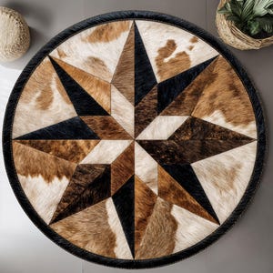 May include: A circular rug with a starburst pattern. The rug has a black leather border and a central star design made from cowhide in shades of brown, black, and cream. The rug's design is geometric and visually striking.