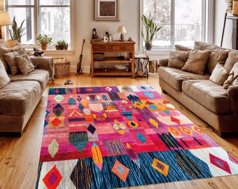May include: A vibrant, rectangular area rug with a geometric pattern. The rug features a mix of colors including pink, blue, orange, and yellow. Diamond and abstract shapes are prominent in the design, creating a bold statement piece for a living room.
