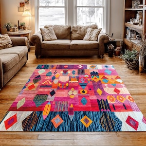 May include: A colourful, geometric area rug with a patchwork design. The rug features a mix of colours including pink, red, blue, orange, and purple. Diamond, rectangle, and triangle shapes are incorporated into the design, creating a bold statement piece.