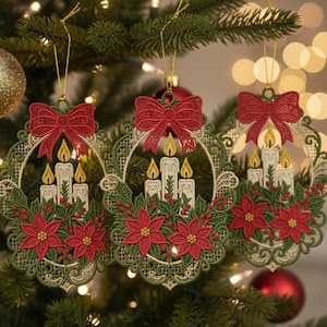 以下が含まれることがあります： 3つのクリスマスツリーのオーナメント。各オーナメントは赤いリボン、ろうそく、ポインセチアが特徴です。オーナメントは緑色で、赤と黄色のアクセントがあり、クリスマスツリーに吊るされています。