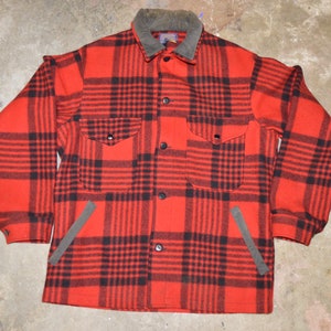 May include: Red and black plaid flannel shirt with a corduroy collar and two flap pockets.