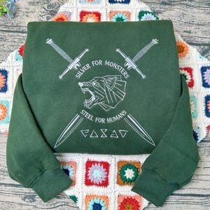 The Witcher Embroidered Sweatshirt: Silver for Monsters, Steel for Humans image 1