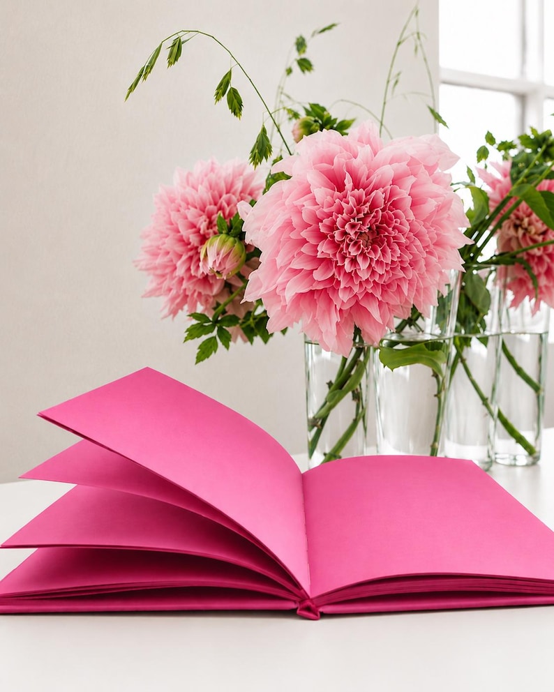 Pink monochrome notebook with matching pink hardcover and pink pages opened flat, showcasing the sewn lay-flat binding, A5 size, premium 120 gsm paper, and minimalist luxury journal design
