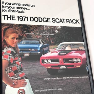 May include: A framed vintage advertisement for the 1971 Dodge Scat Pack. The image shows a red Dodge Charger Super Bee and a blue Dodge, with the text "If you want more run for your money... join the Pack."