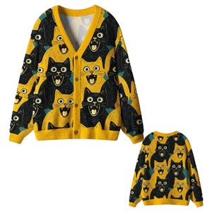 May include: A long-sleeve V-neck cardigan and a matching long-sleeve crew neck sweater featuring an all-over graphic print of black and yellow cats with wide-open mouths. The cardigan has a front button closure with brown buttons.