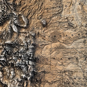 May include: A detailed, three-dimensional map of the central United States, featuring states like Nebraska, Kansas, and Colorado. The map has a vintage aesthetic with a brown and tan color palette, highlighting topographical features.