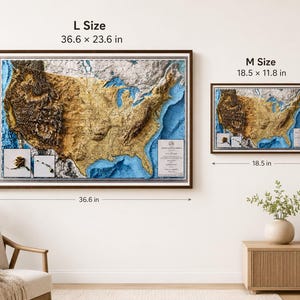 May include: Two framed relief maps of the United States, one large (36.6 x 23.6 inches) and one medium (18.5 x 11.8 inches). The maps feature detailed topography in shades of brown and gold, with blue representing water bodies. The frames are dark brown.