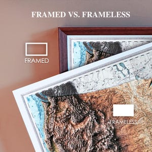 May include: Comparison of framed and frameless map art. The framed map has a dark brown wooden frame, while the frameless map is displayed without a border. The maps feature a detailed relief of a landmass with blue and brown tones. Text at the top reads "FRAMED VS. FRAMELESS."