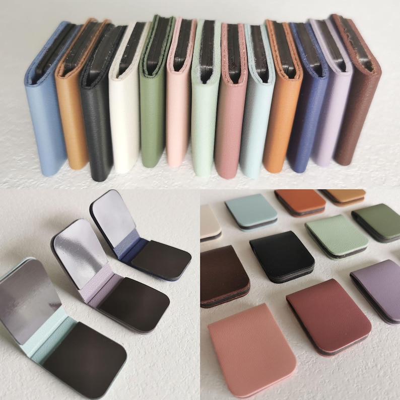 May include: A collection of rectangular magnetic clips in various solid colors including blue, tan, black, white, green, pink, and purple. The clips feature a smooth, matte-textured exterior and a dark interior surface with a strong magnetic closure.
