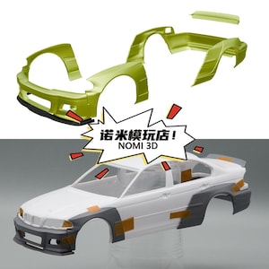 May include: A lime green plastic car body kit with a separate spoiler and a white model car body featuring grey fender flares attached with small pieces of brown adhesive tape. A white speech bubble contains the text 诺米模玩店! NOMI 3D.