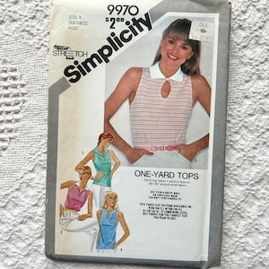 May include: Simplicity sewing pattern number 9970 for a one-yard top. The pattern is for sizes 8, 10, and 12. The pattern shows three different tops with a white collar and a keyhole opening in the front. The pattern is for stretch knit fabric.